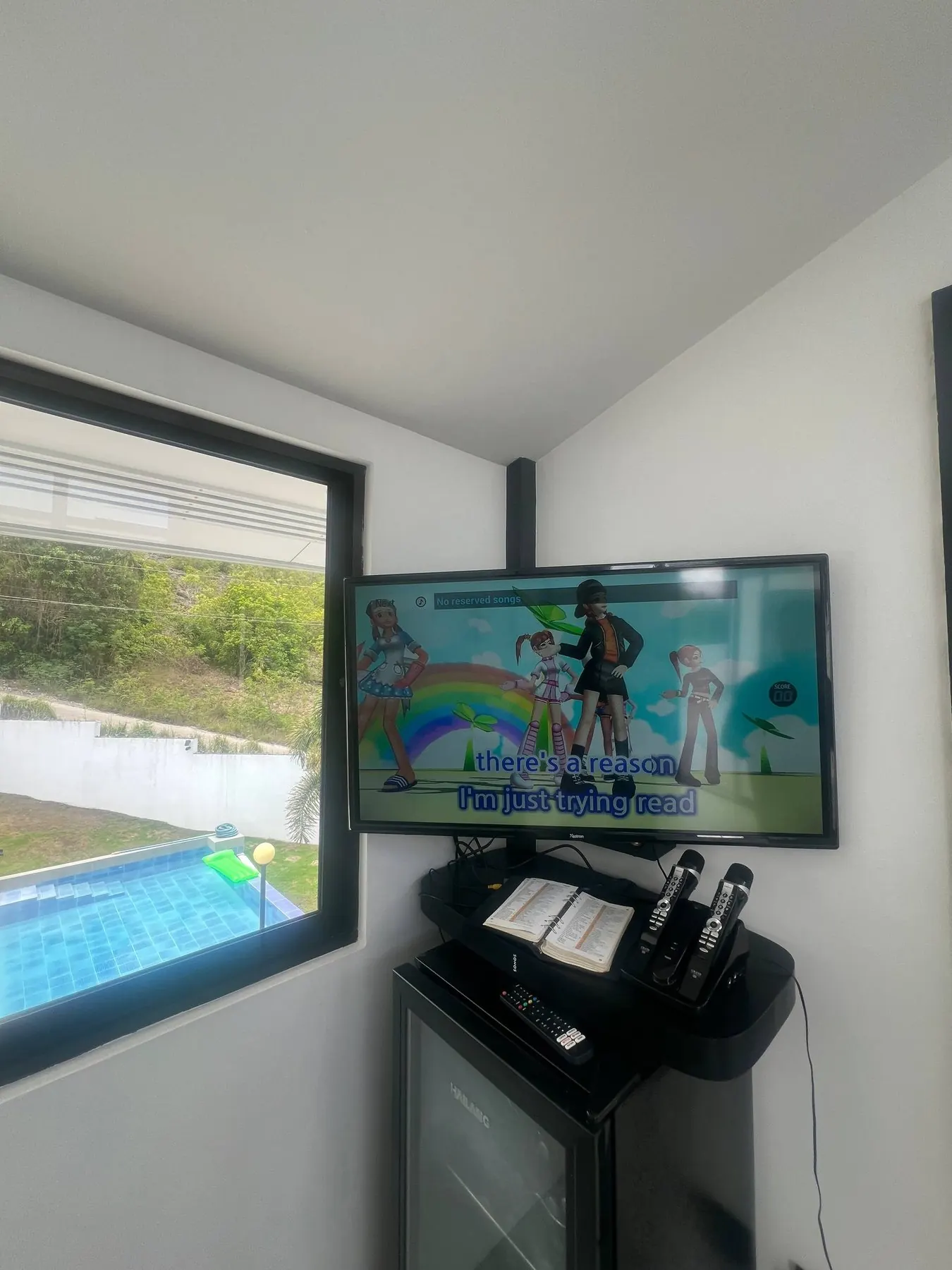 Karaoke screen and microphones overlooking the pool