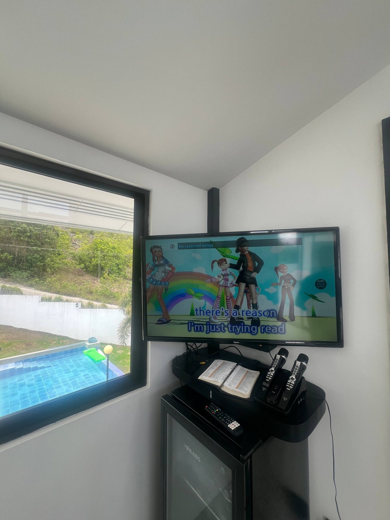 Karaoke screen and microphones overlooking the pool