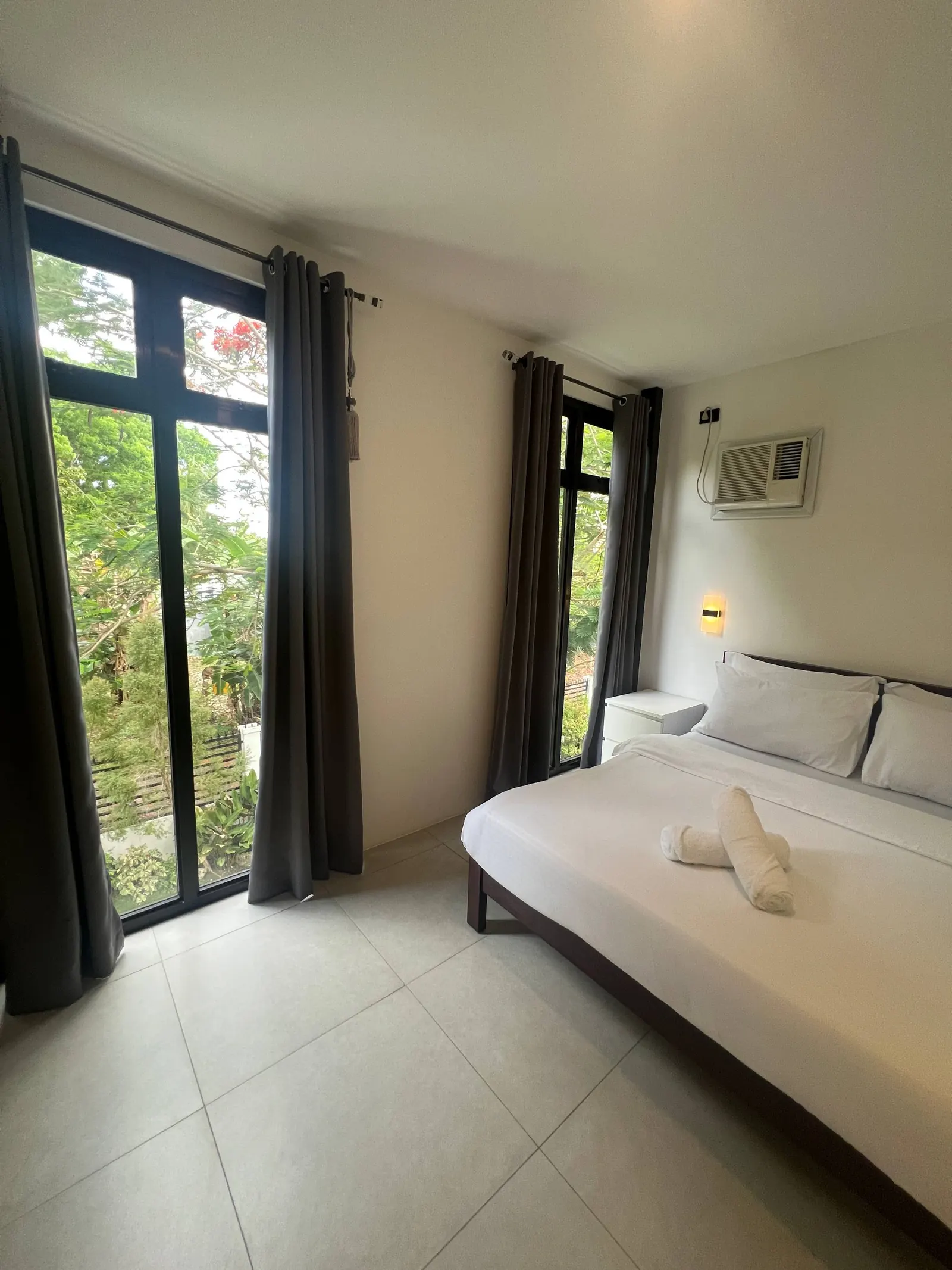 Bedroom 2 bed and sliding glass windows to tropical garden