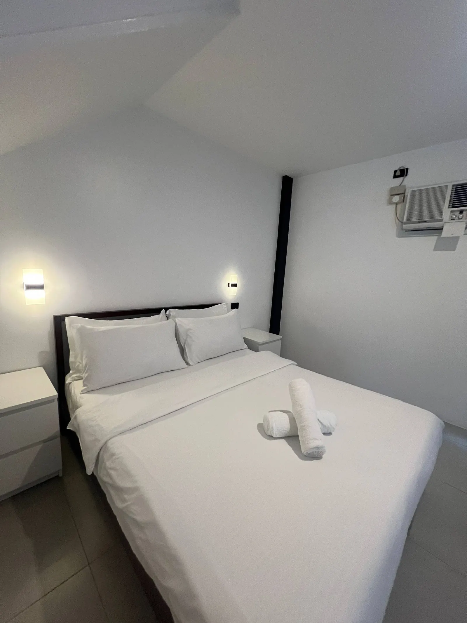 Bedroom 3 bed with decorative towels and nightstands
