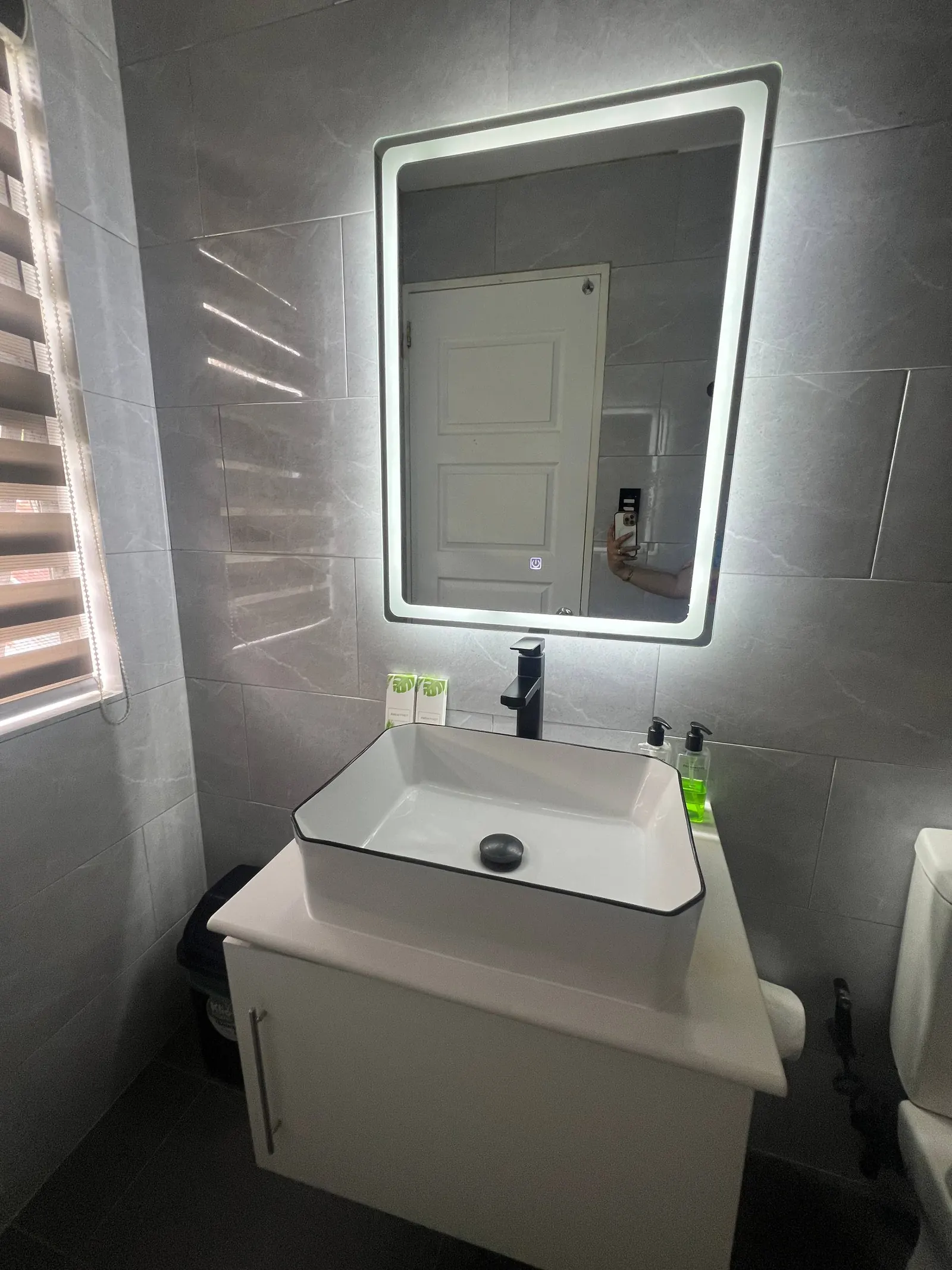En-suite mirror reflection and toilet area