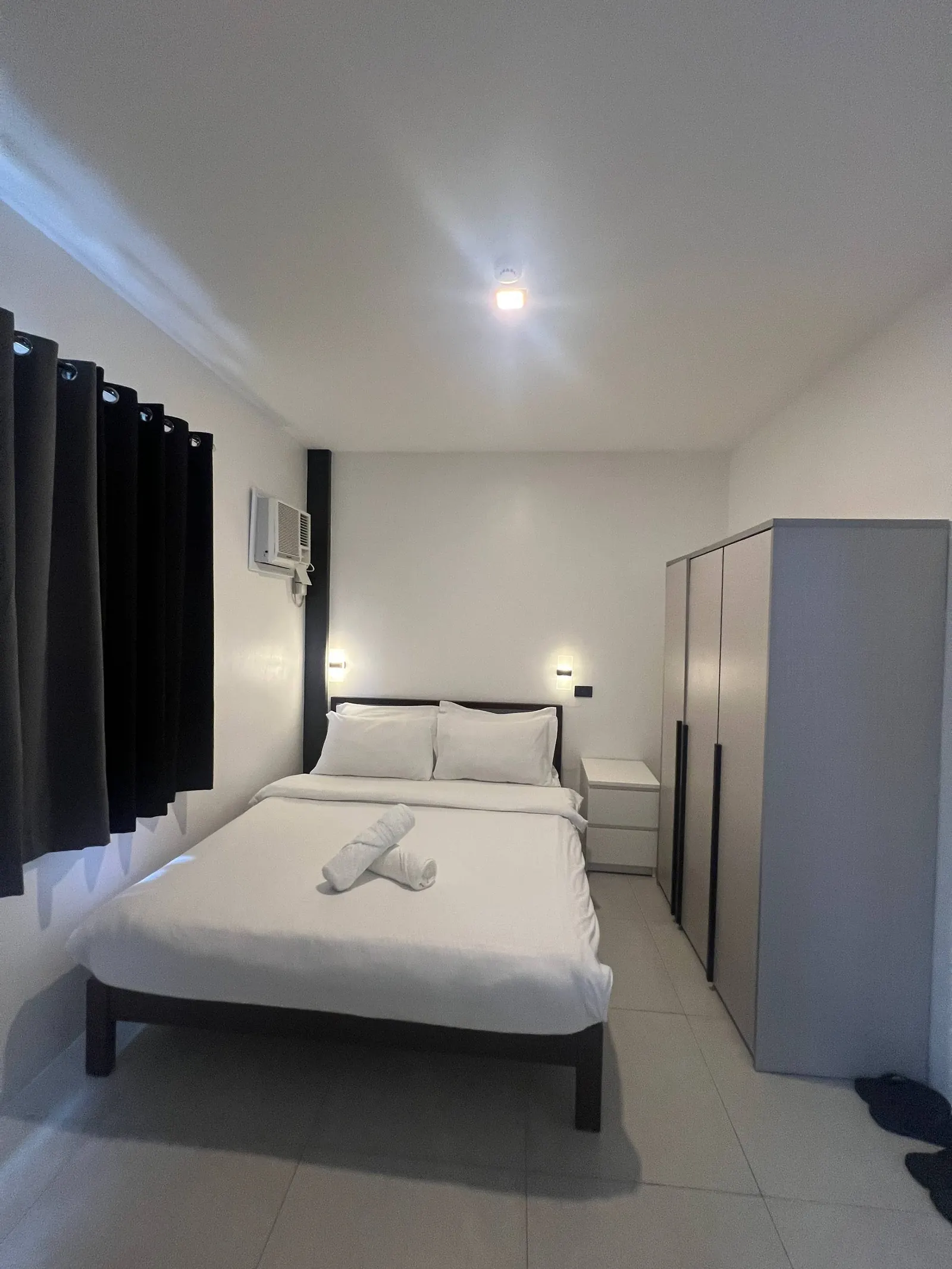Bedroom 4 rear outlook with queen bed and dark wood frame