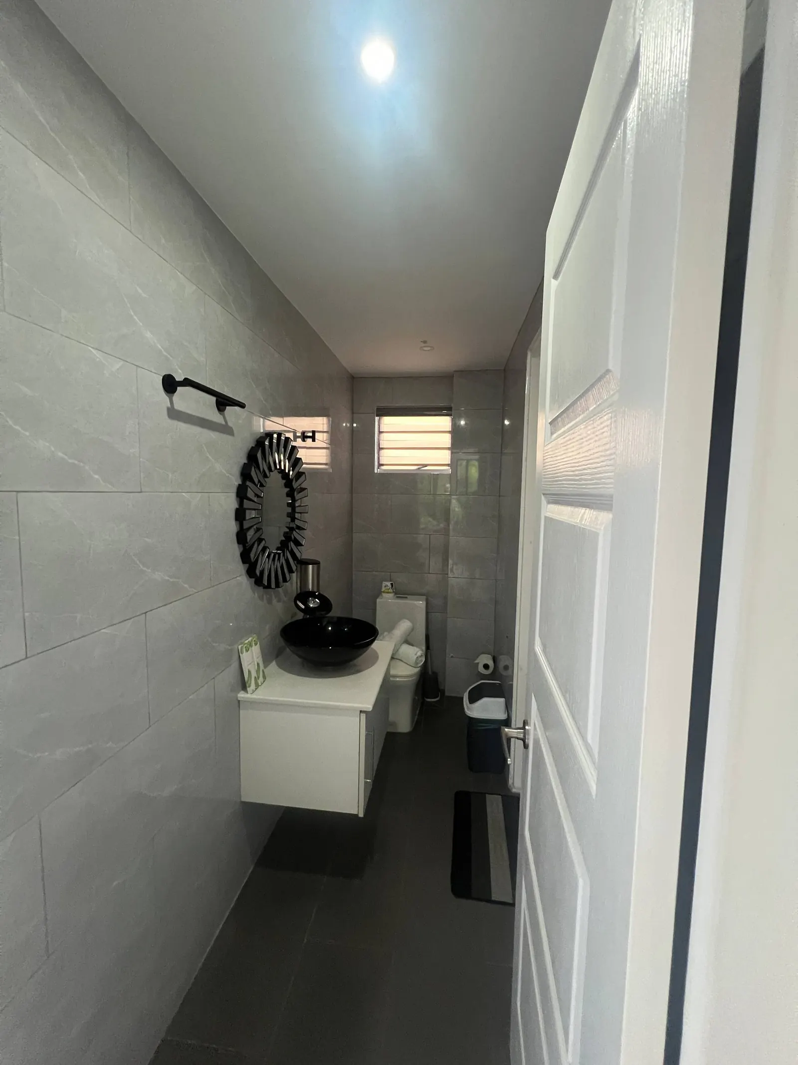 En-suite narrow view with towel bar, mirror and toilet