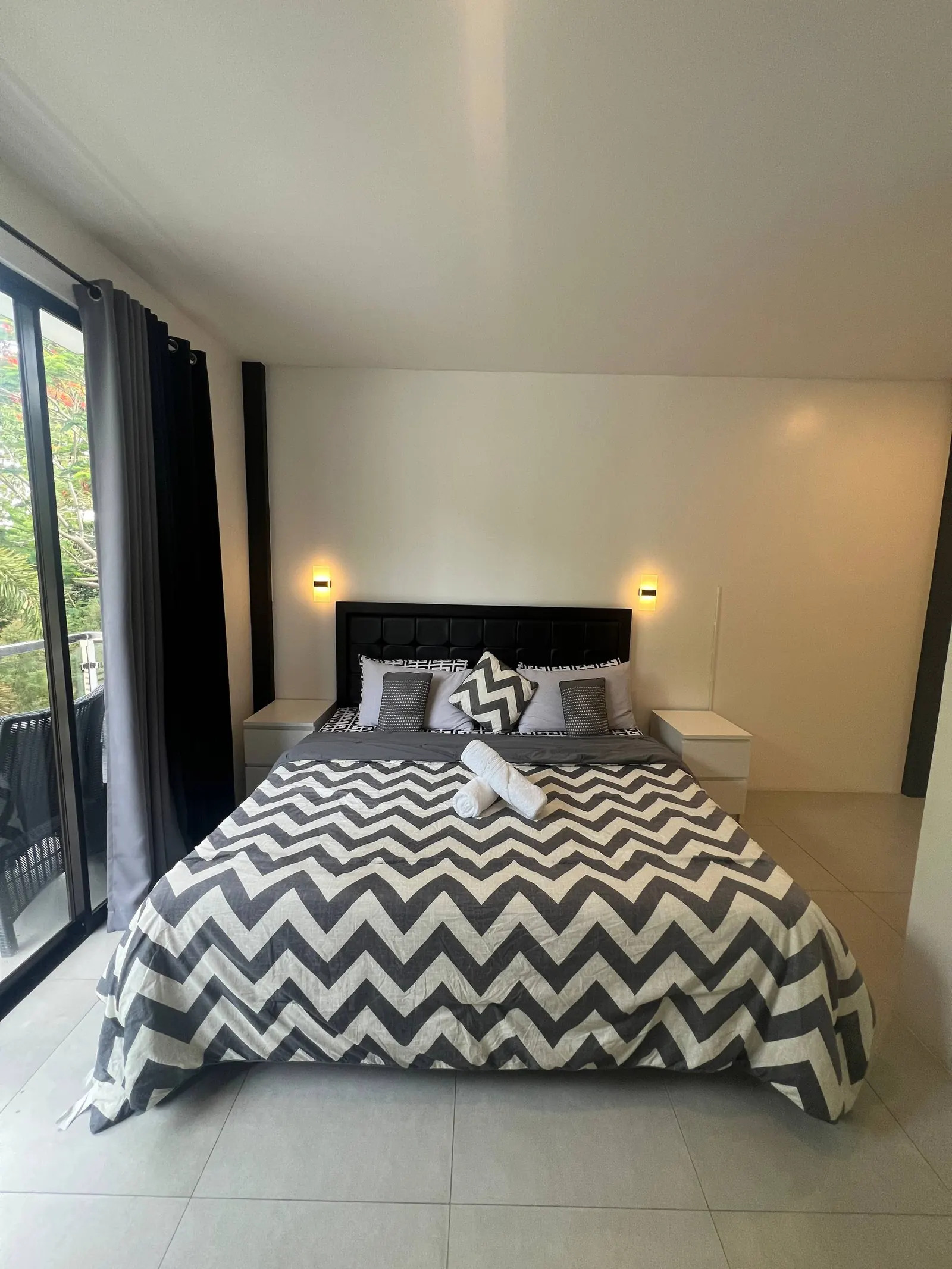 Master bedroom with king bed, chevron bedding and private balcony