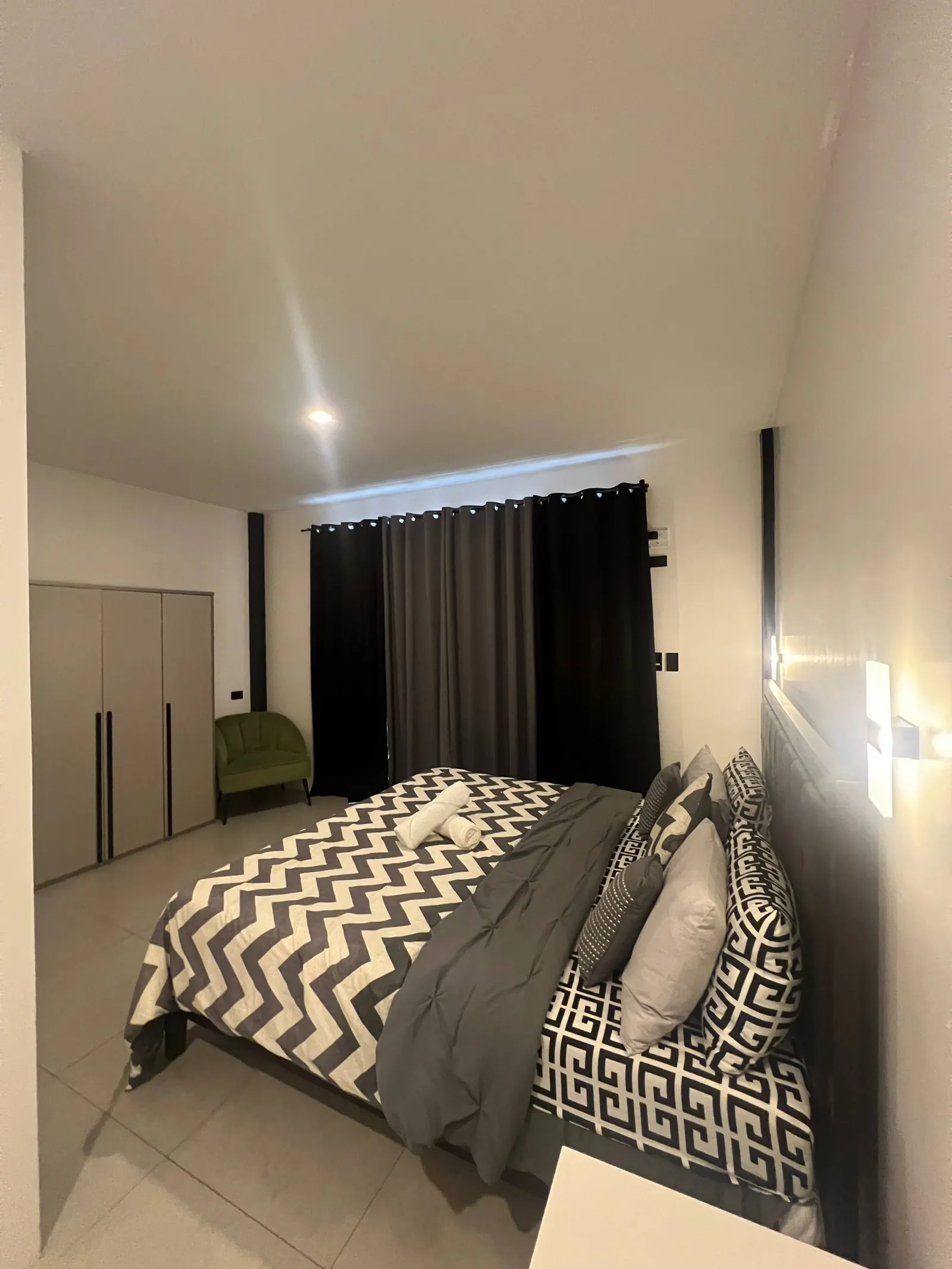Master bedroom with wardrobe and lounge chair