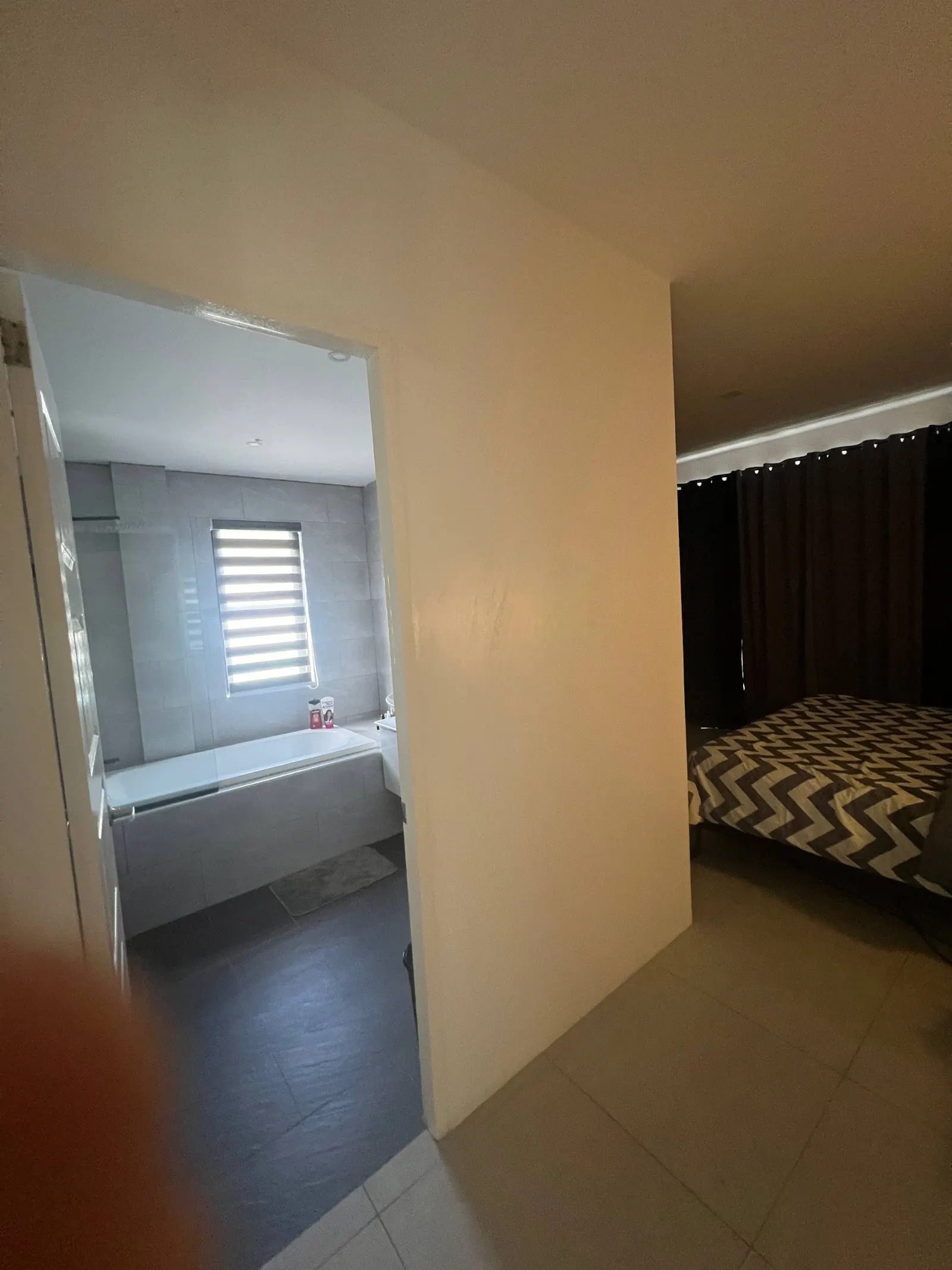 En-suite bathroom with bathtub and glass shower