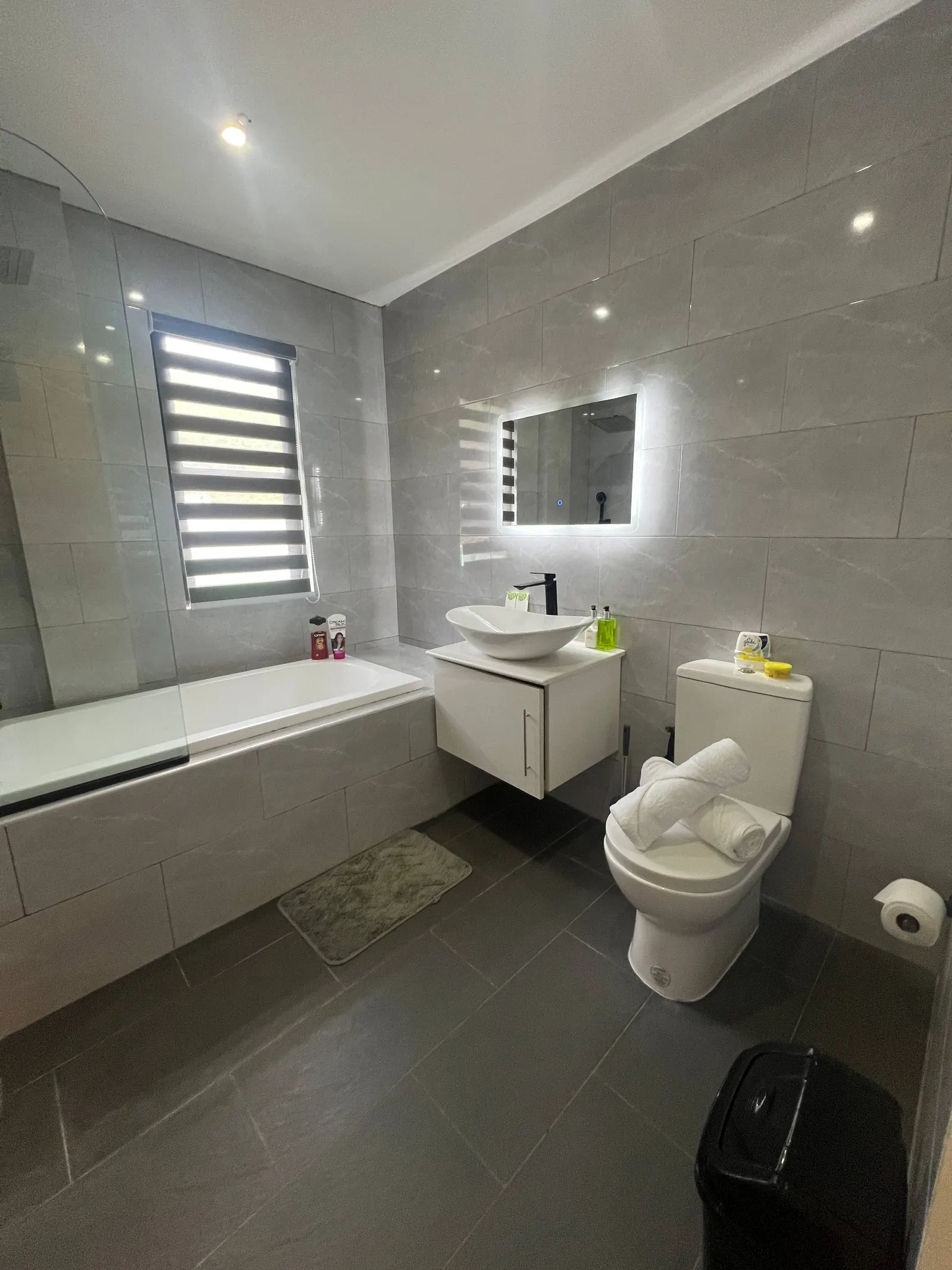 En-suite bathroom with black fixtures and marble tiles