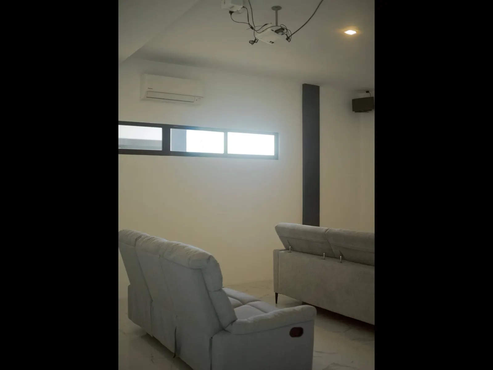 Private cinema room with projector, air conditioning and reclining sofas