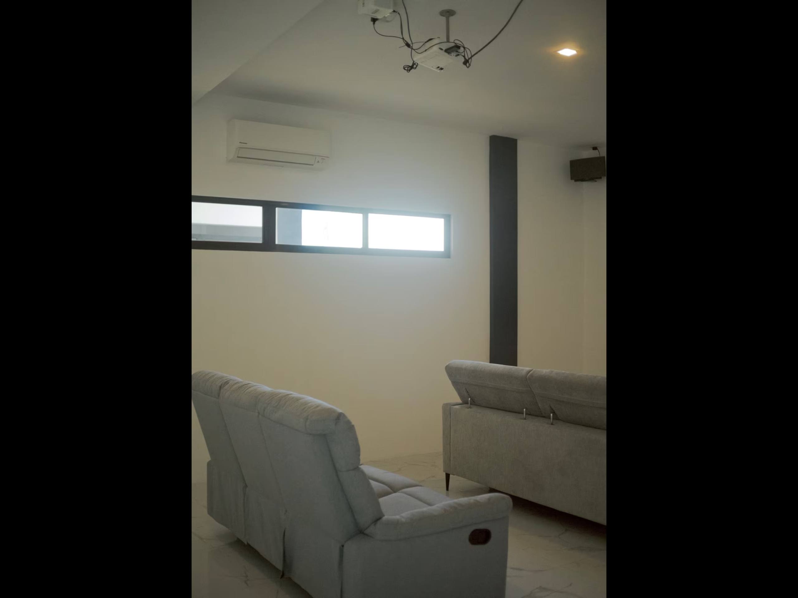 Private cinema room with projector, air conditioning and reclining sofas