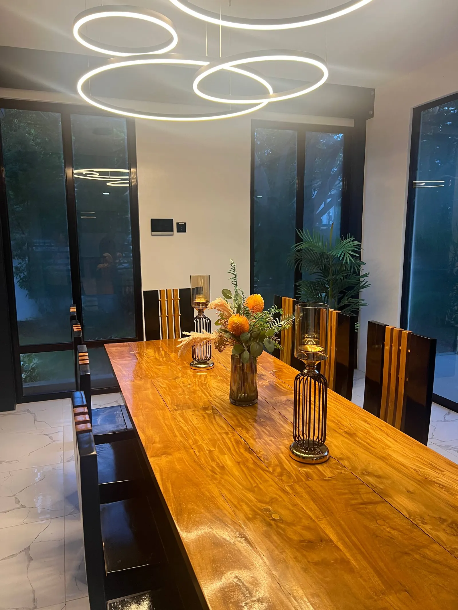 Dining table with floral centrepiece and ring chandelier