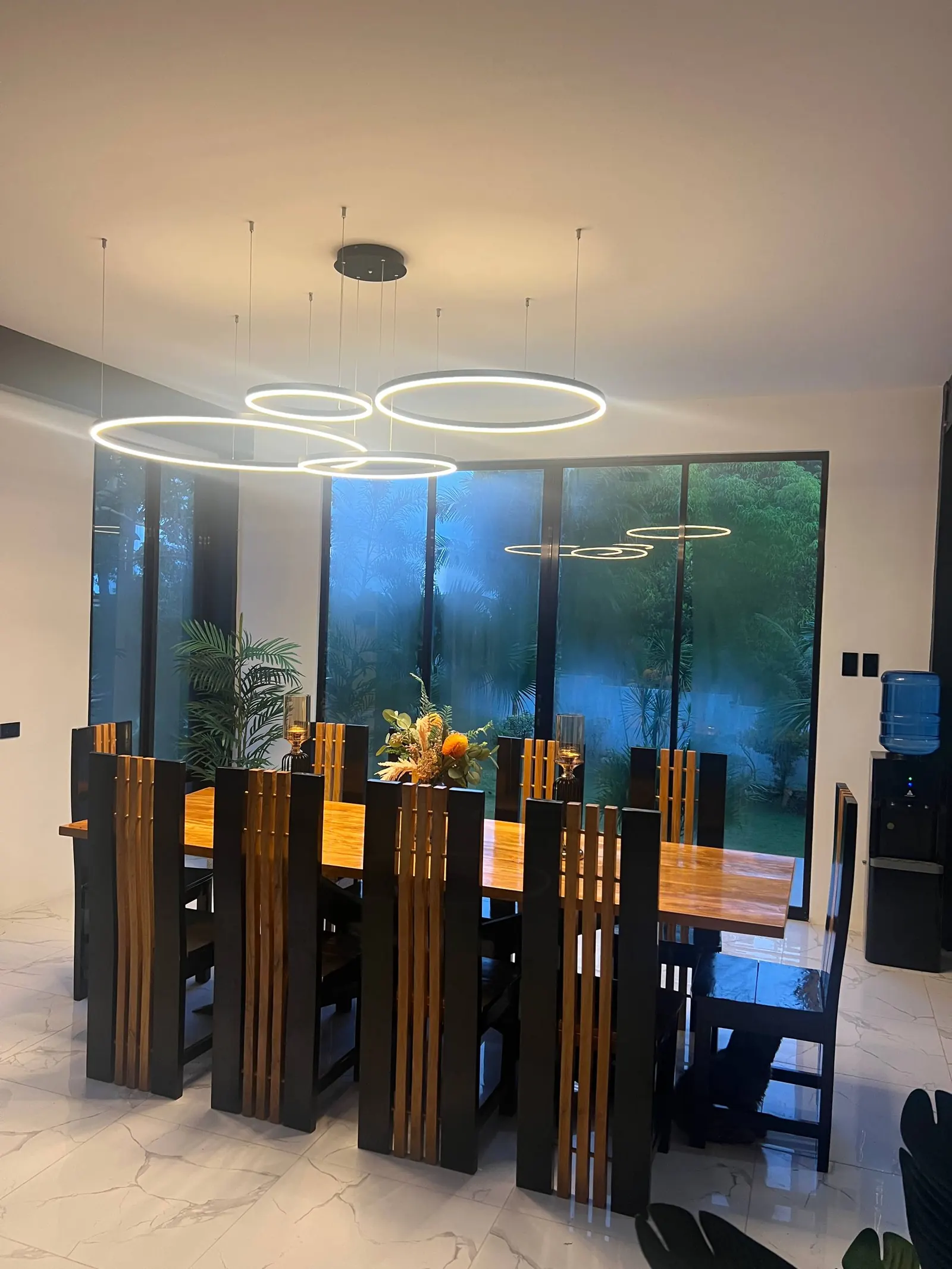 Spacious dining room with marble floors and garden view
