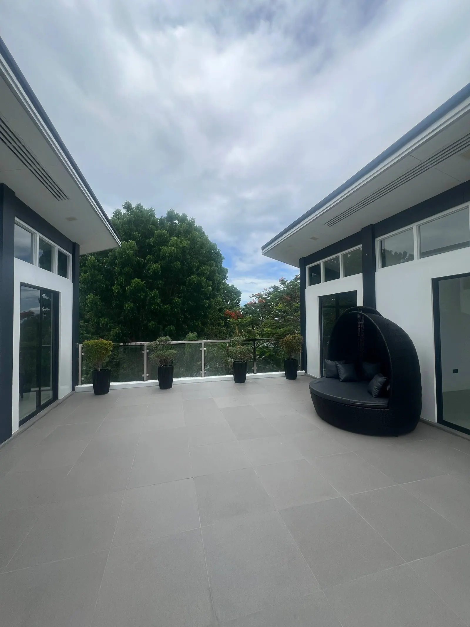 Rooftop terrace with outdoor daybed and planters